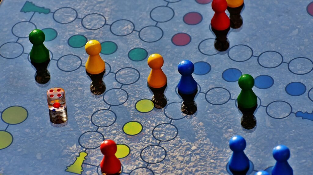 Close-up of a colorful board game with pawns and a dice, perfect for family fun.
